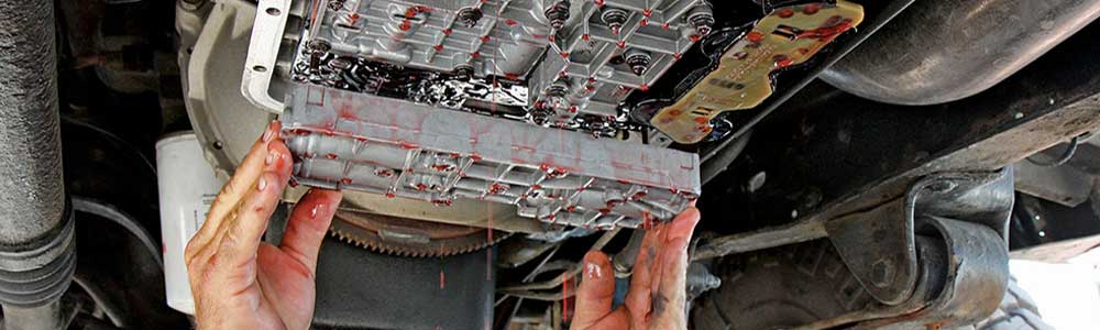 a mechanic handling a car part